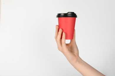 Photo of Woman holding paper cup on white background, closeup. Mockup for design