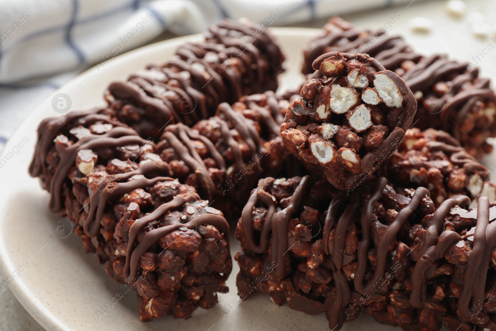 Photo of Delicious chocolate puffed rice bars on table, closeup