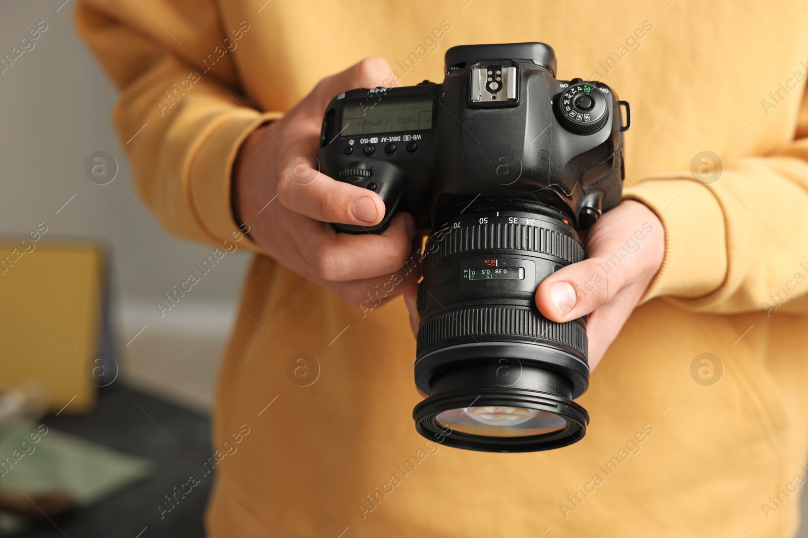 Photo of Photographer with professional camera in studio, closeup