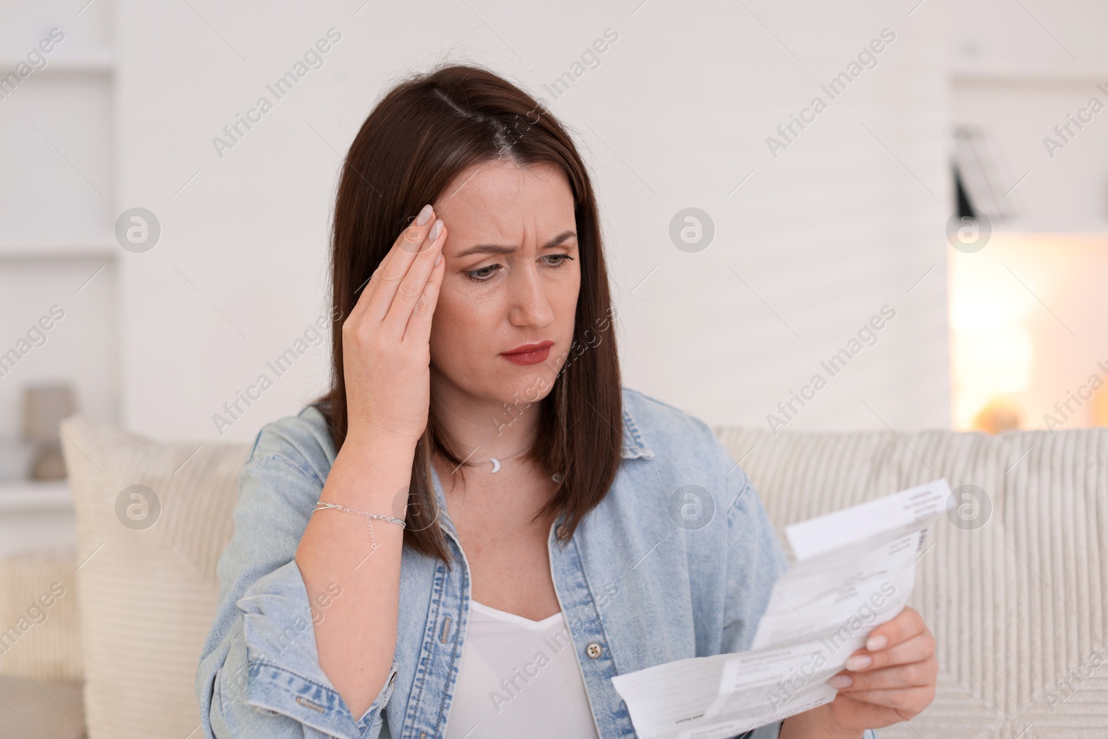 Photo of Worried woman reading pills side effects and instruction indoors