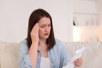 Photo of Worried woman reading pills side effects and instruction indoors