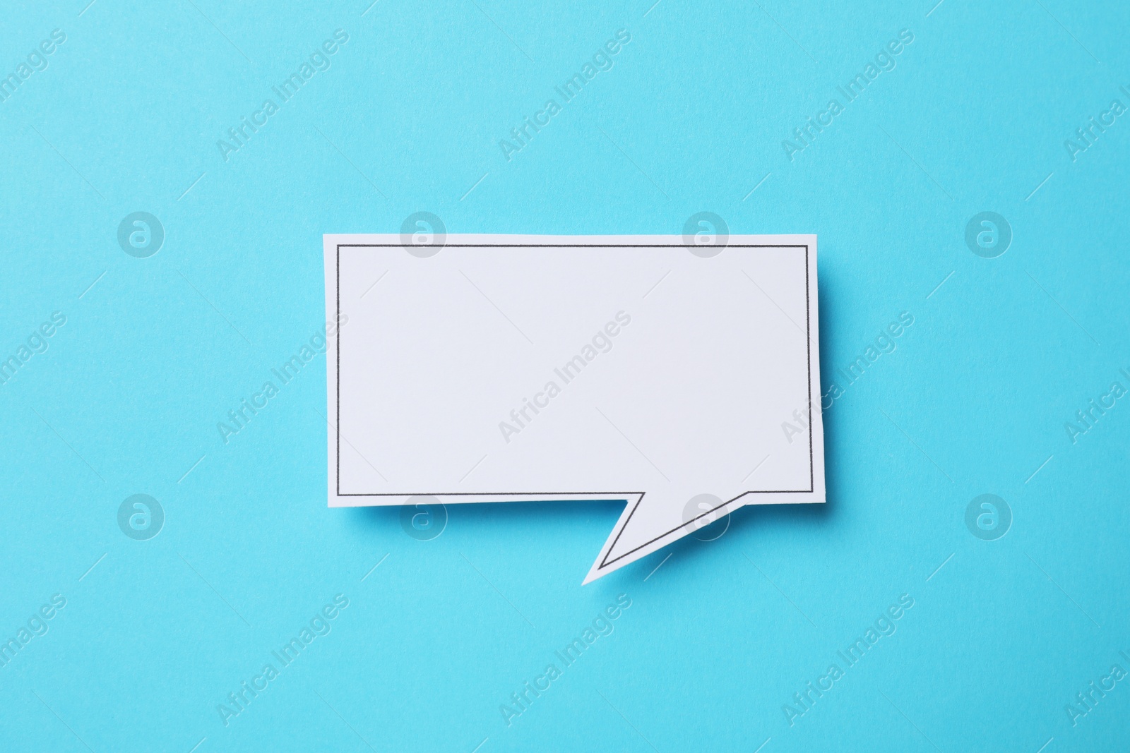 Photo of Blank speech bubble on light blue background, top view. Space for text