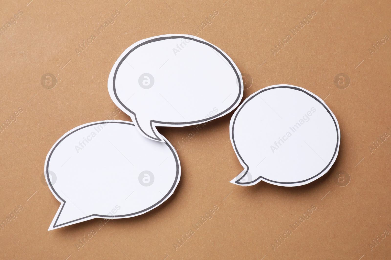 Photo of Blank speech bubbles on brown background. Space for text