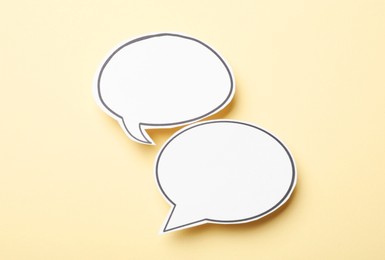 Photo of Blank speech bubbles on beige background. Space for text