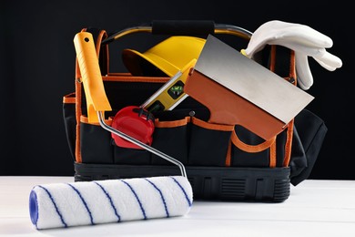 Photo of Different construction material and tools on white wooden table