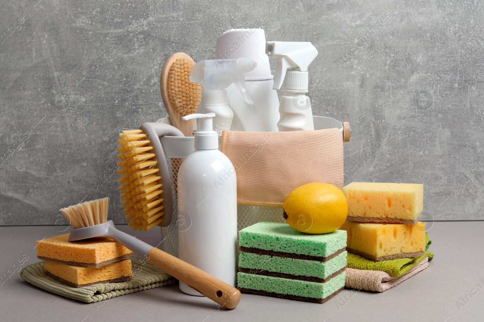 Photo of Eco-friendly cleaning products and supplies on grey table