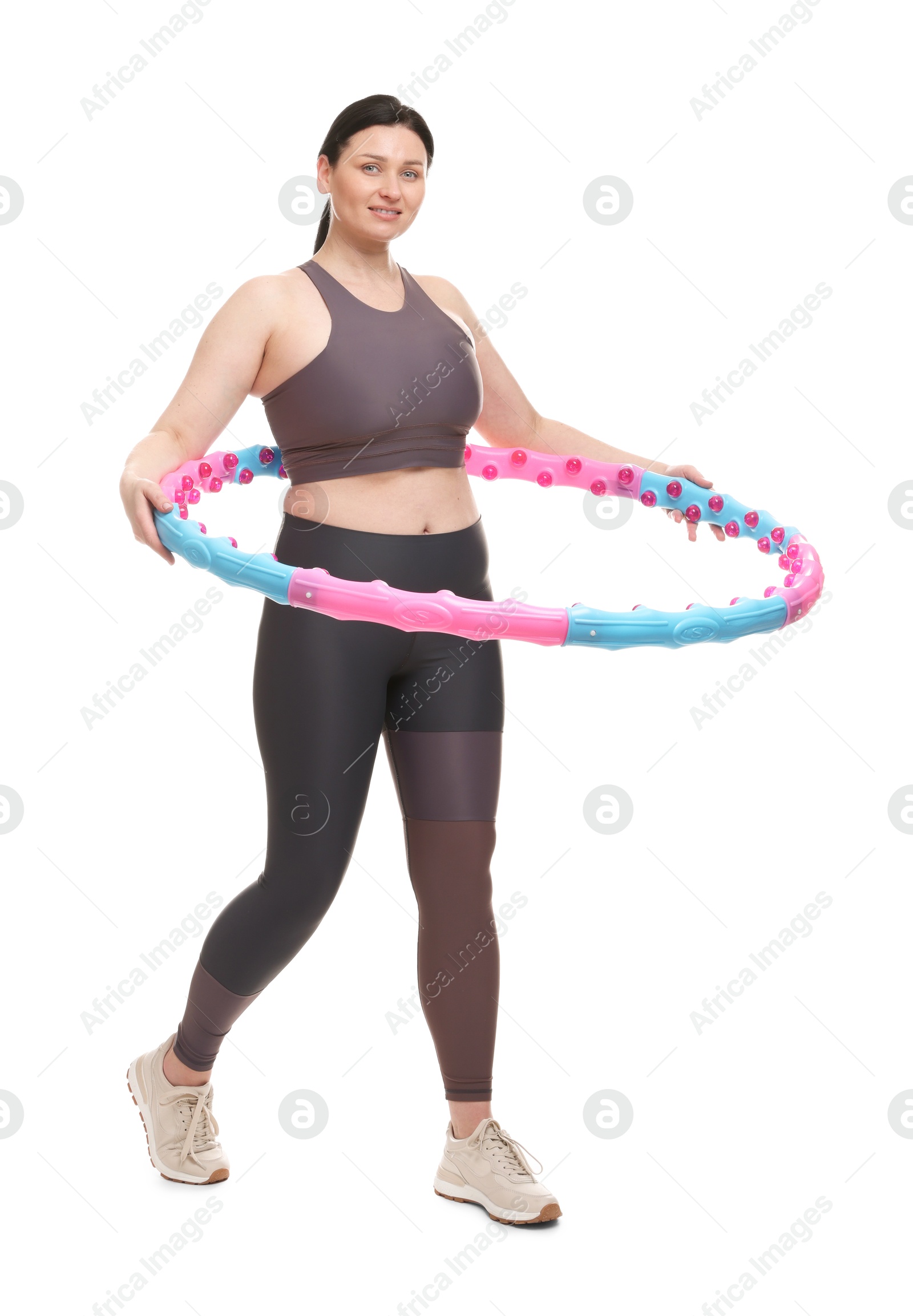 Photo of Plus size woman in gym clothes with hula hoop on white background