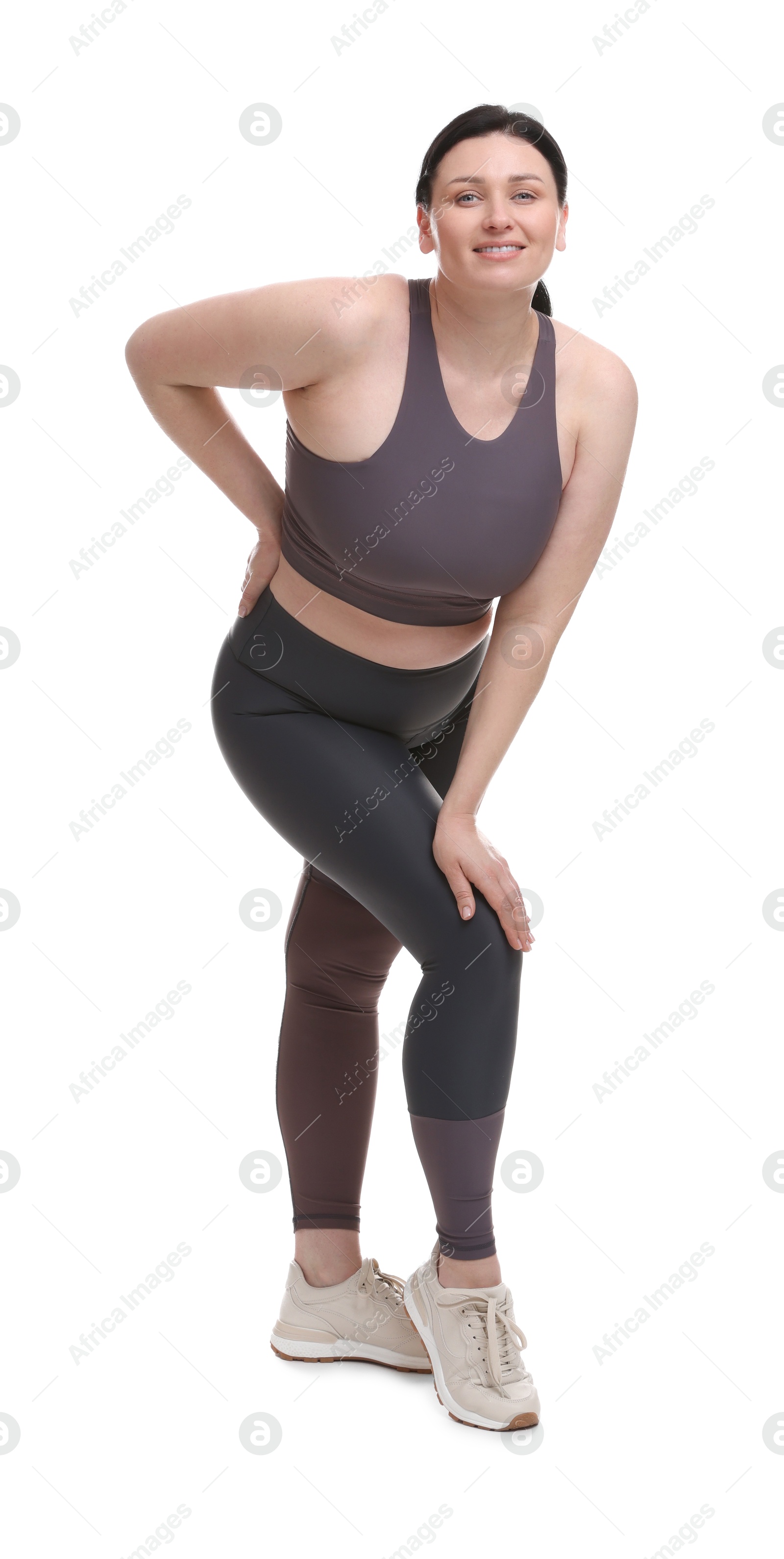 Photo of Plus size woman in gym clothes on white background