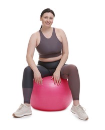 Photo of Plus size woman in gym clothes with fitness ball on white background