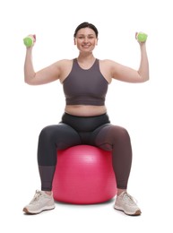 Photo of Plus size woman in gym clothes with fitness ball and dumbbells on white background