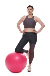 Photo of Plus size woman in gym clothes with fitness ball on white background