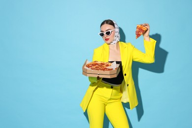 Stylish woman with delicious pizza on light blue background, space for text