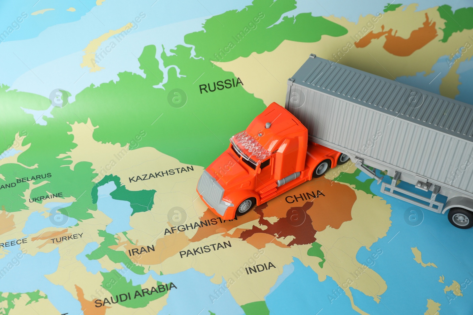 Photo of Toy truck on world map. Logistics concept