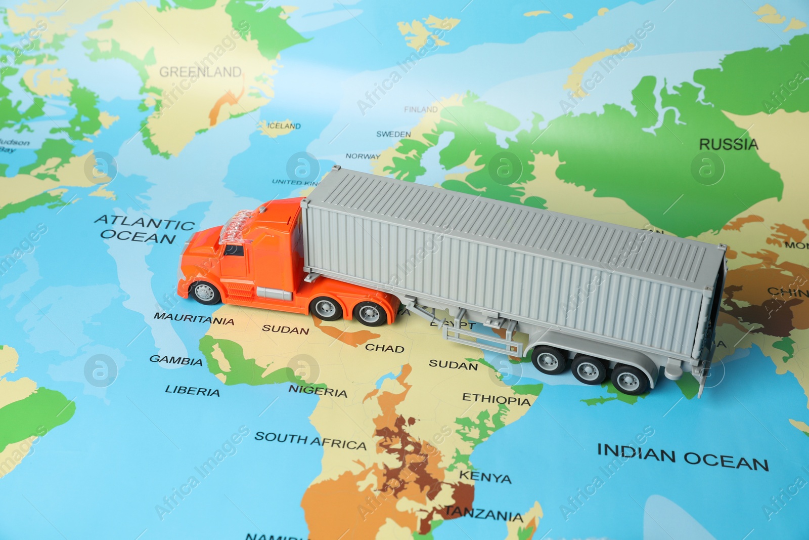 Photo of Toy truck on world map. Logistics concept