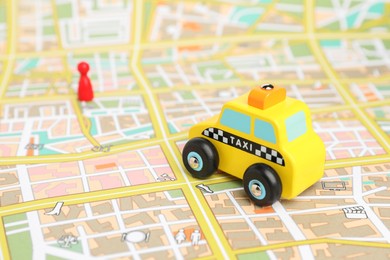 Photo of Yellow taxi car on city map. Road trip