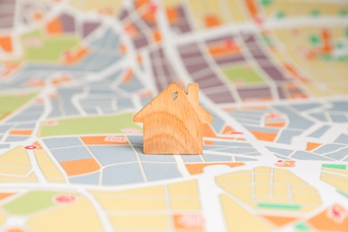 Photo of One wooden house model on city map. Accommodation search