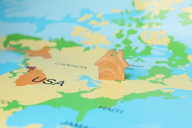 Photo of Wooden house model on world map. Accommodation search