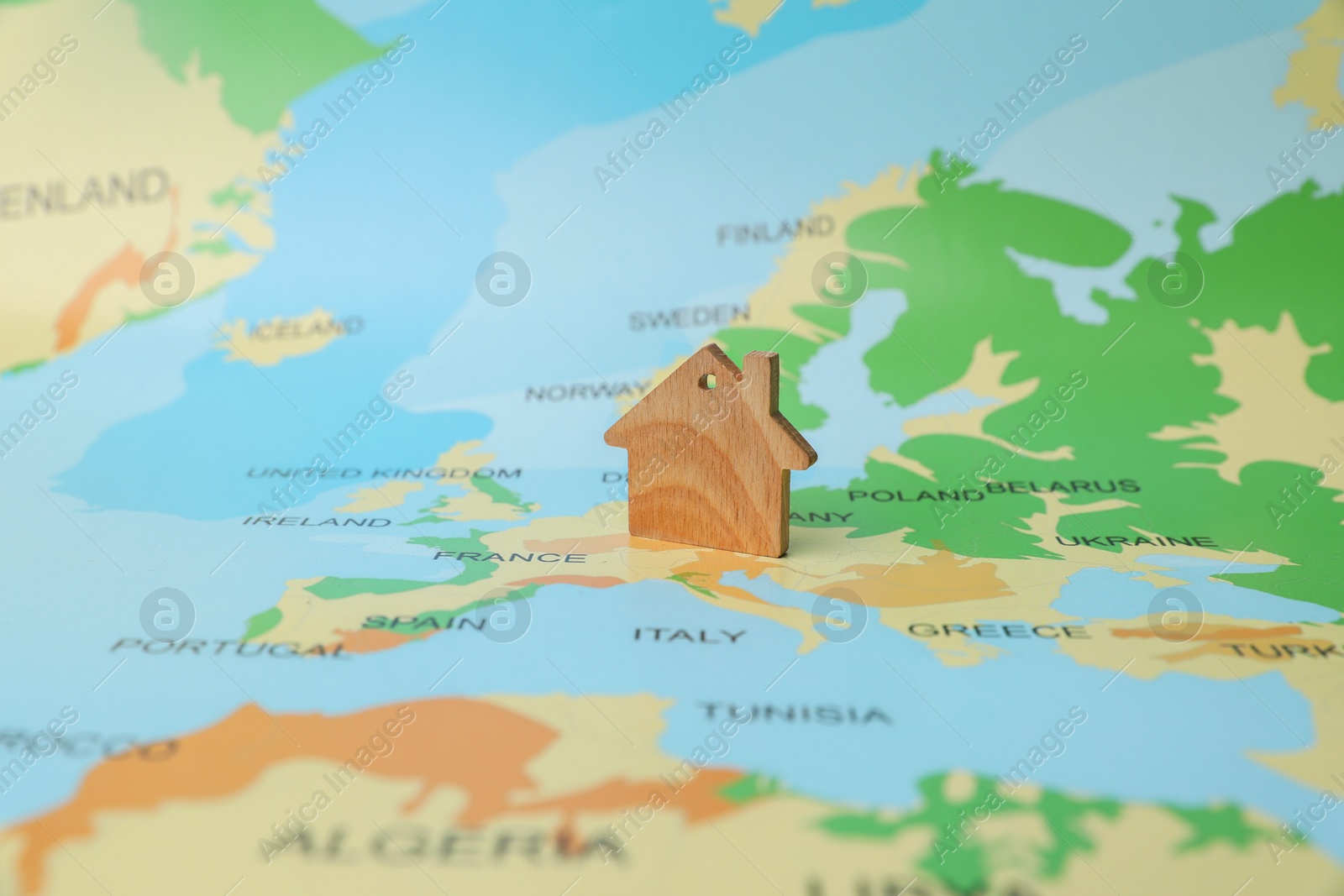 Photo of One wooden house model on world map. Accommodation search