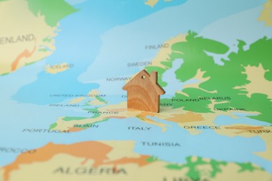 Photo of One wooden house model on world map. Accommodation search