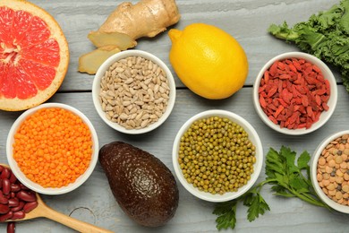 Photo of Superfood. Different healthy food products on grey wooden table, flat lay