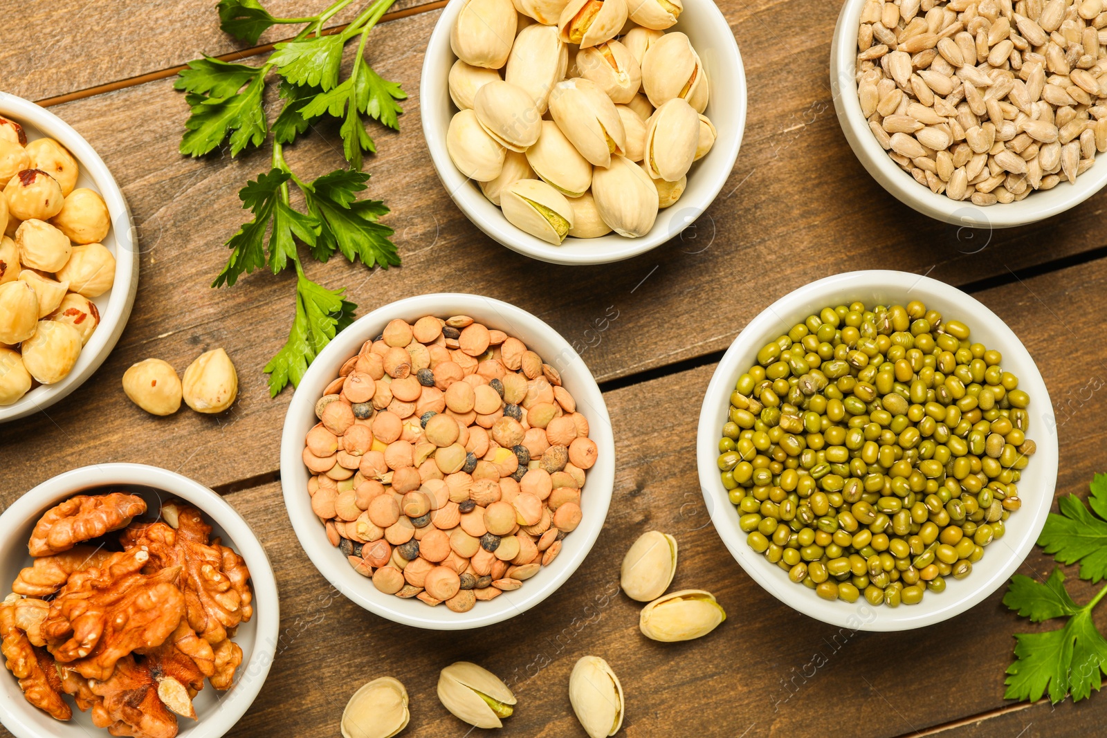 Photo of Superfood. Different healthy food products on wooden table, flat lay