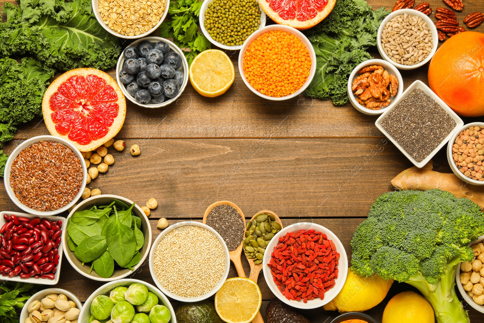 Photo of Superfood. Frame of different healthy food products on wooden table, flat lay. Space for text