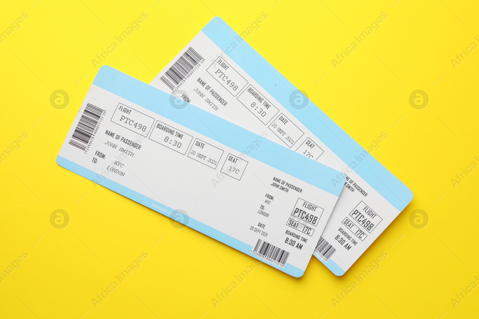 Photo of Travel agency. Flight tickets on yellow background, top view