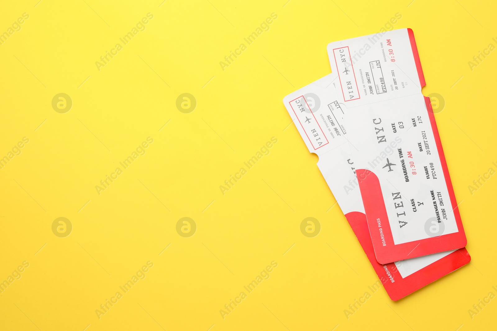 Photo of Travel agency. Flight tickets on yellow background, top view. Space for text