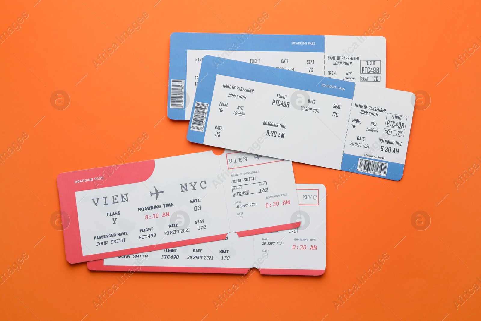 Photo of Travel agency. Flight tickets on orange background, flat lay