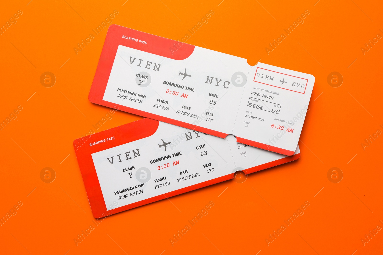 Photo of Travel agency. Flight tickets on orange background, top view