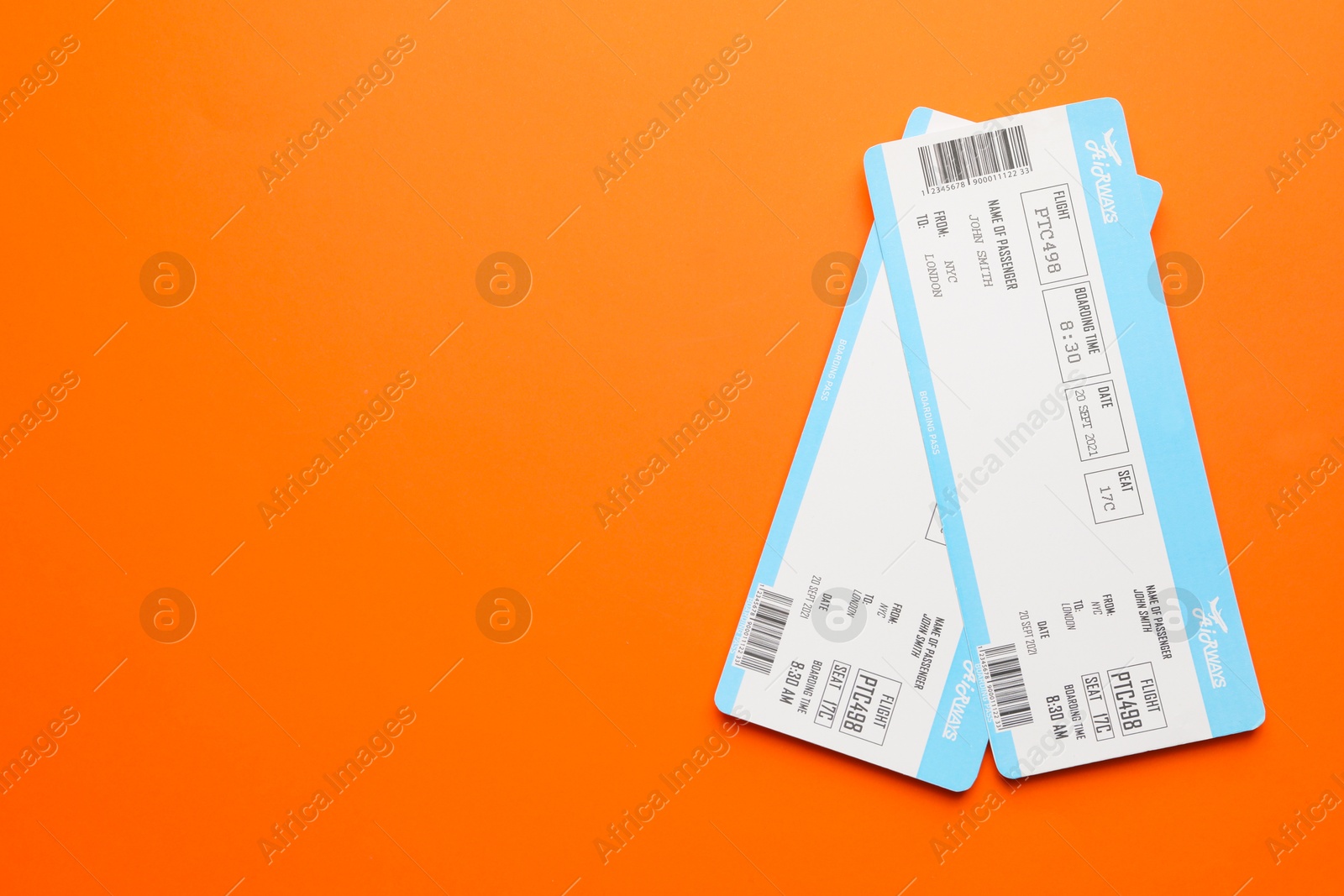 Photo of Travel agency. Flight tickets on orange background, top view. Space for text