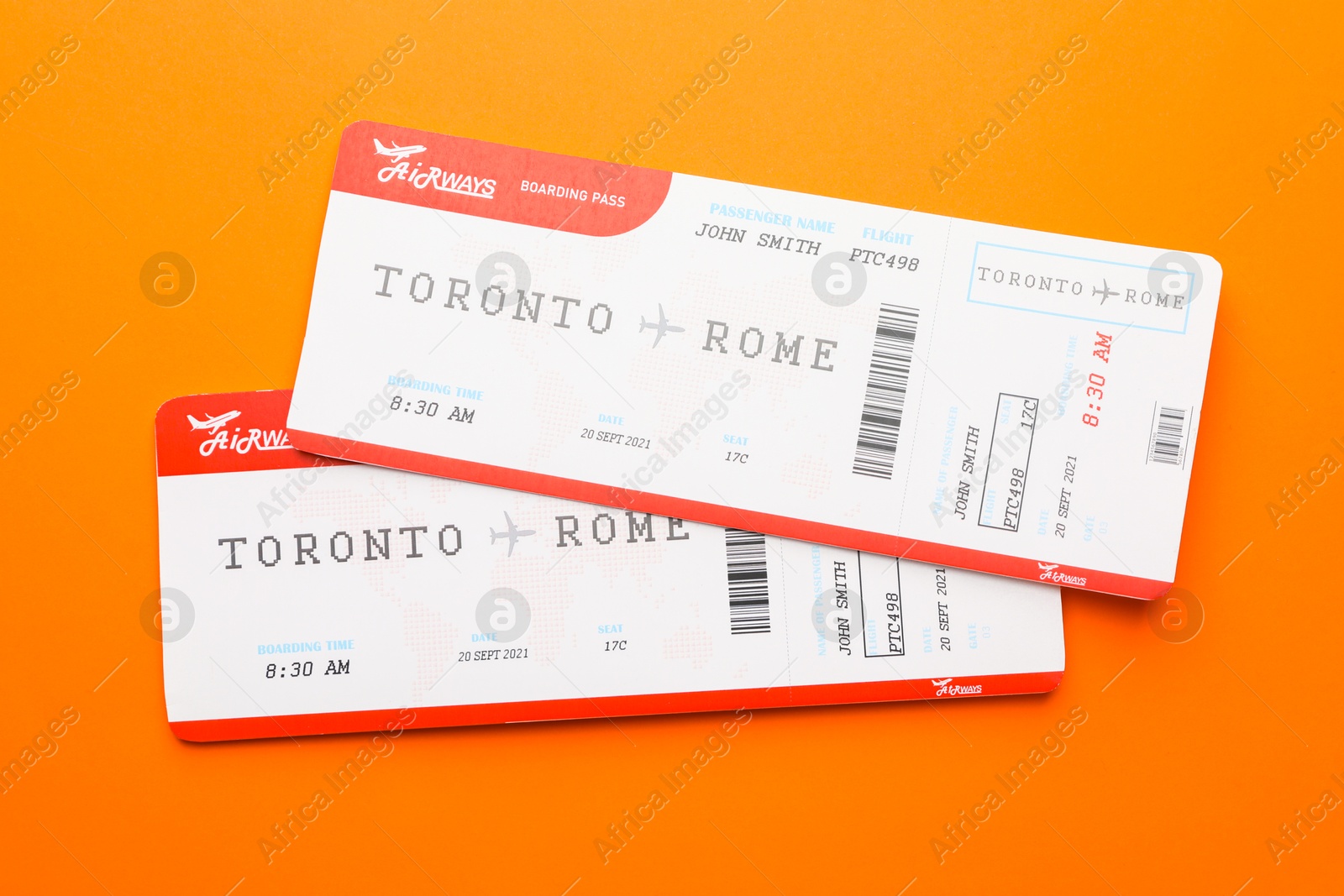 Photo of Travel agency. Flight tickets on orange background, top view