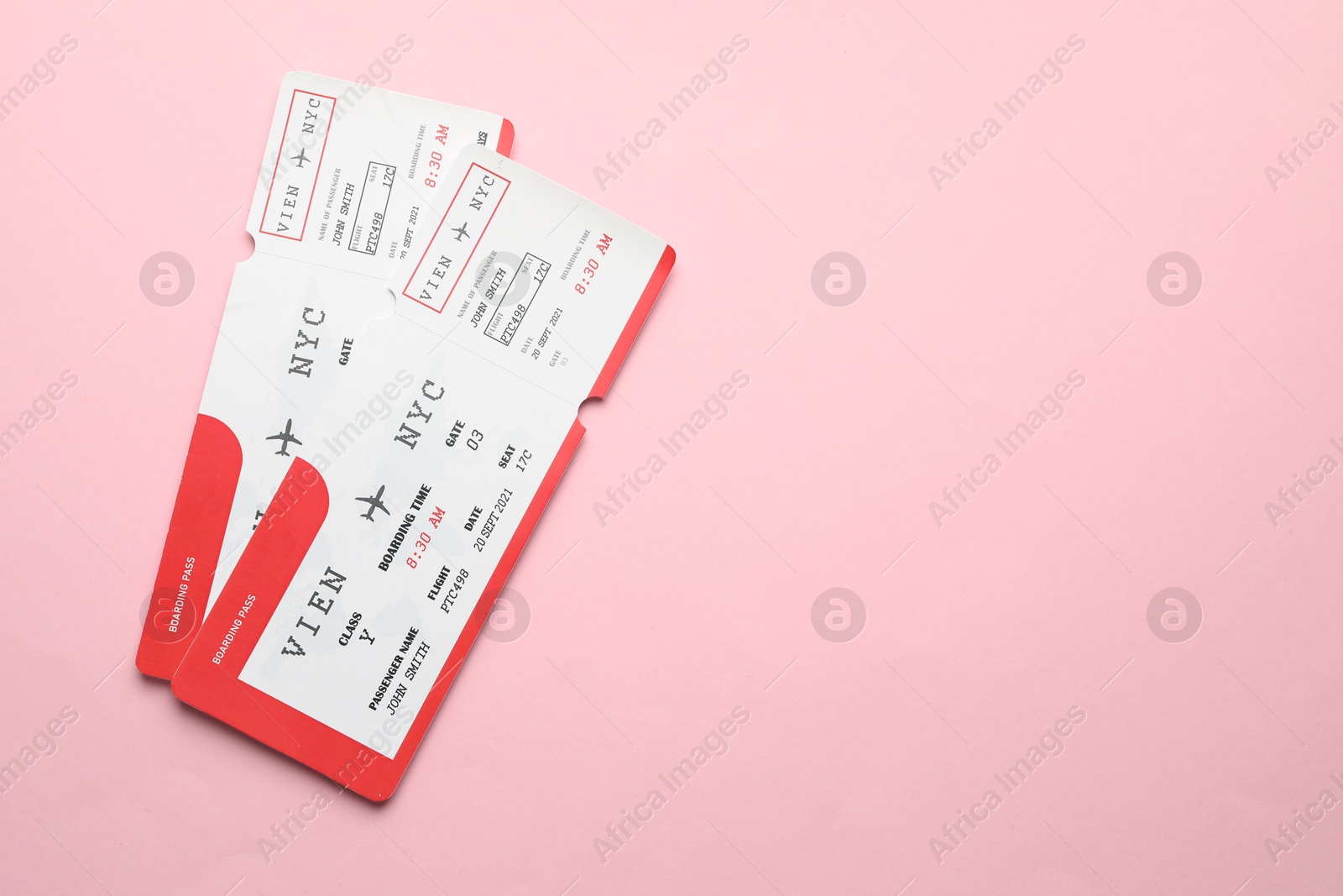 Photo of Travel agency. Flight tickets on pink background, top view. Space for text