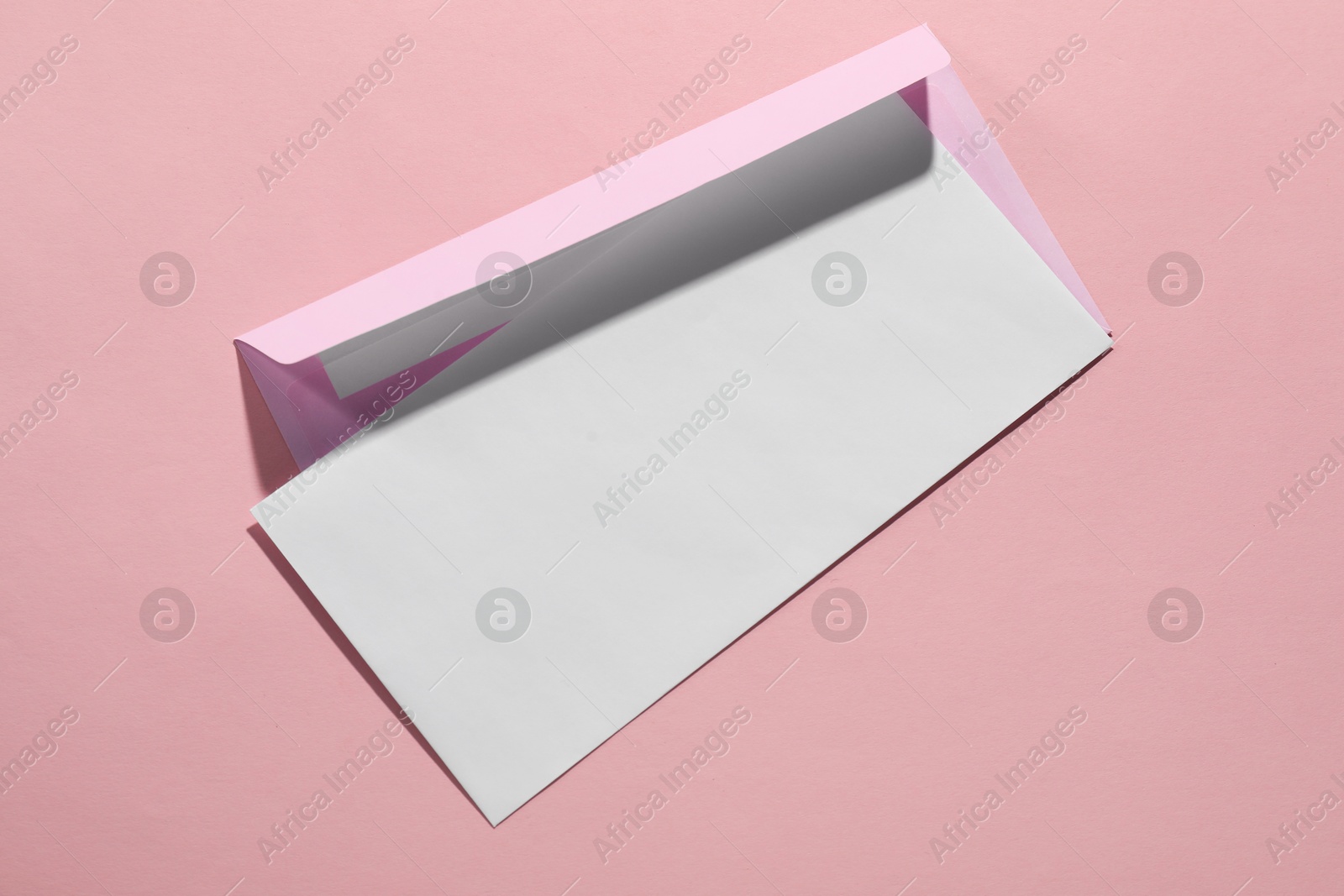 Photo of Paper envelopes on pink background, top view. Mockup for design