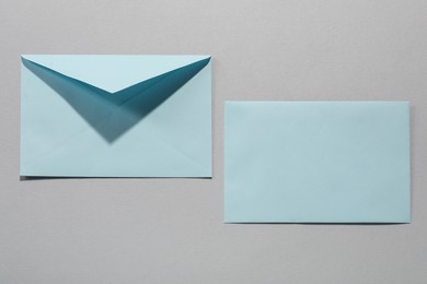 Photo of Paper envelopes on grey background, above view. Mockup for design