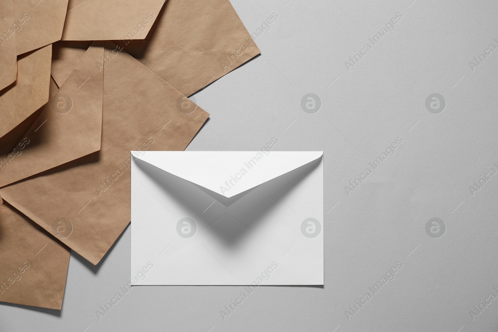 Photo of Paper envelopes on gray background, flat lay. Mockup for design