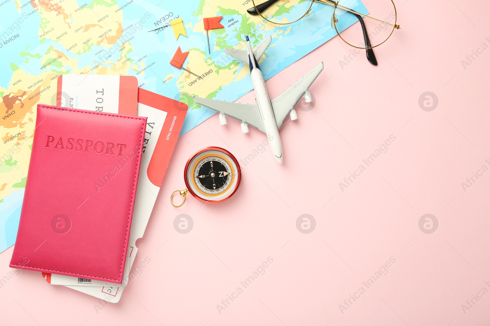 Photo of Flat lay composition with passport and tickets on pink background, space for text