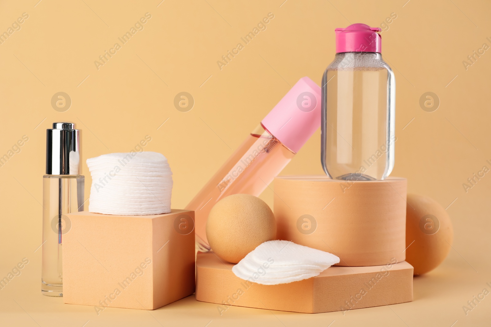 Photo of Clean cotton pads and cosmetic products on beige background