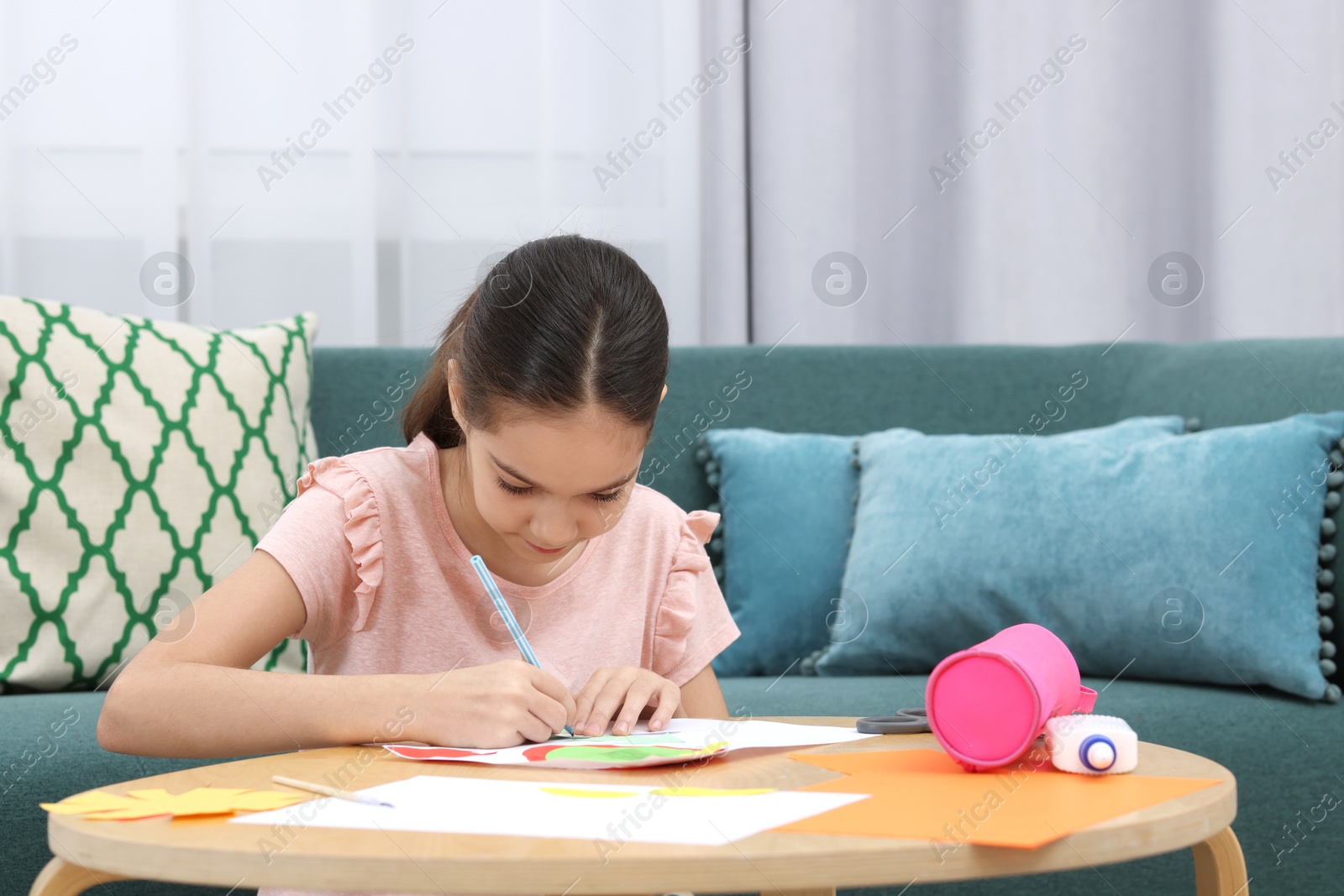 Photo of Girl drawing card at table indoors. Art and craft