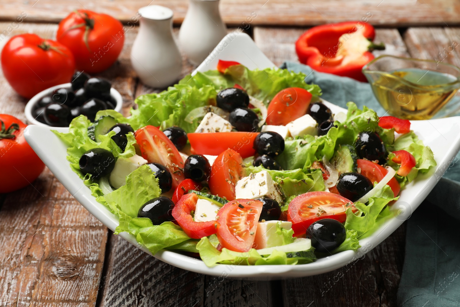 Delicious fresh Greek salad on wooden table, closeup Photo of Delicious fresh Greek salad on wooden table, closeup
