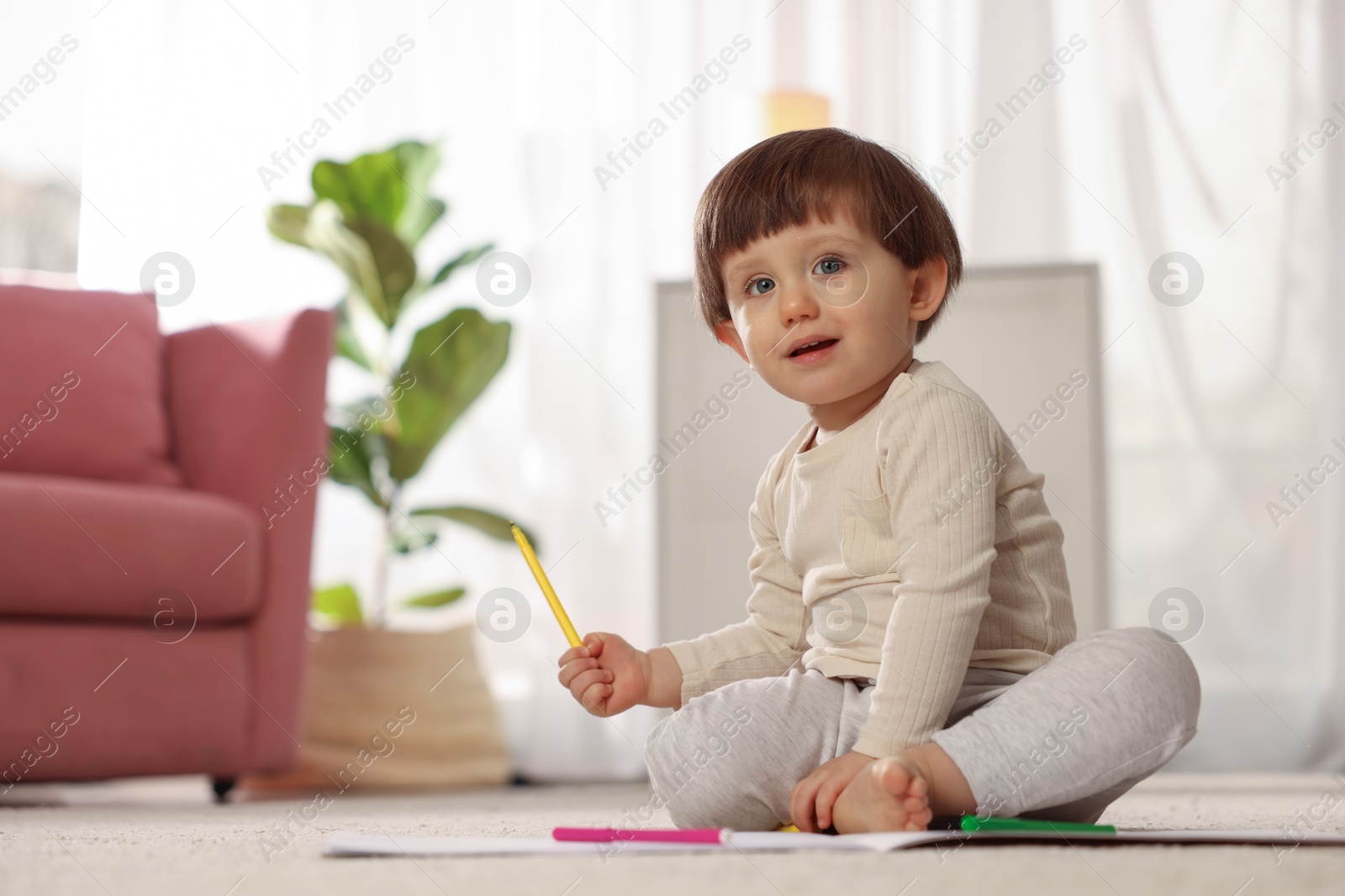 Photo of Cute little boy felt pen on floor at home, space for text