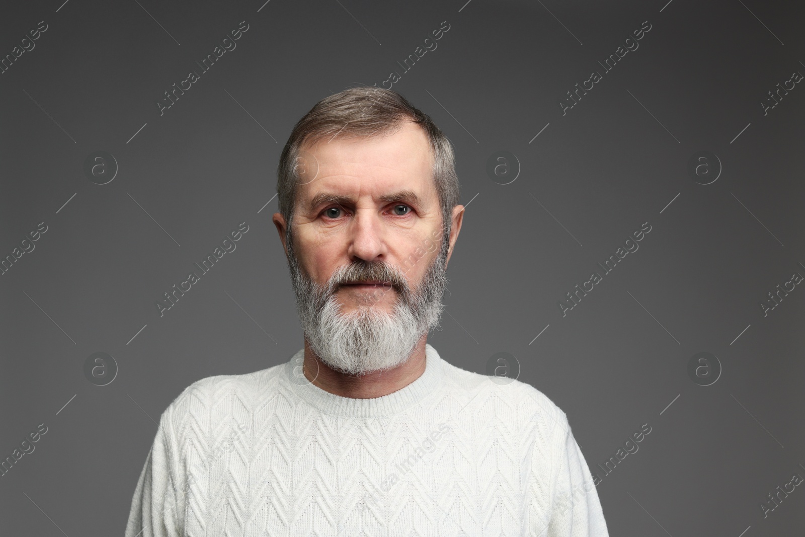 Photo of Portrait of mature man on grey background