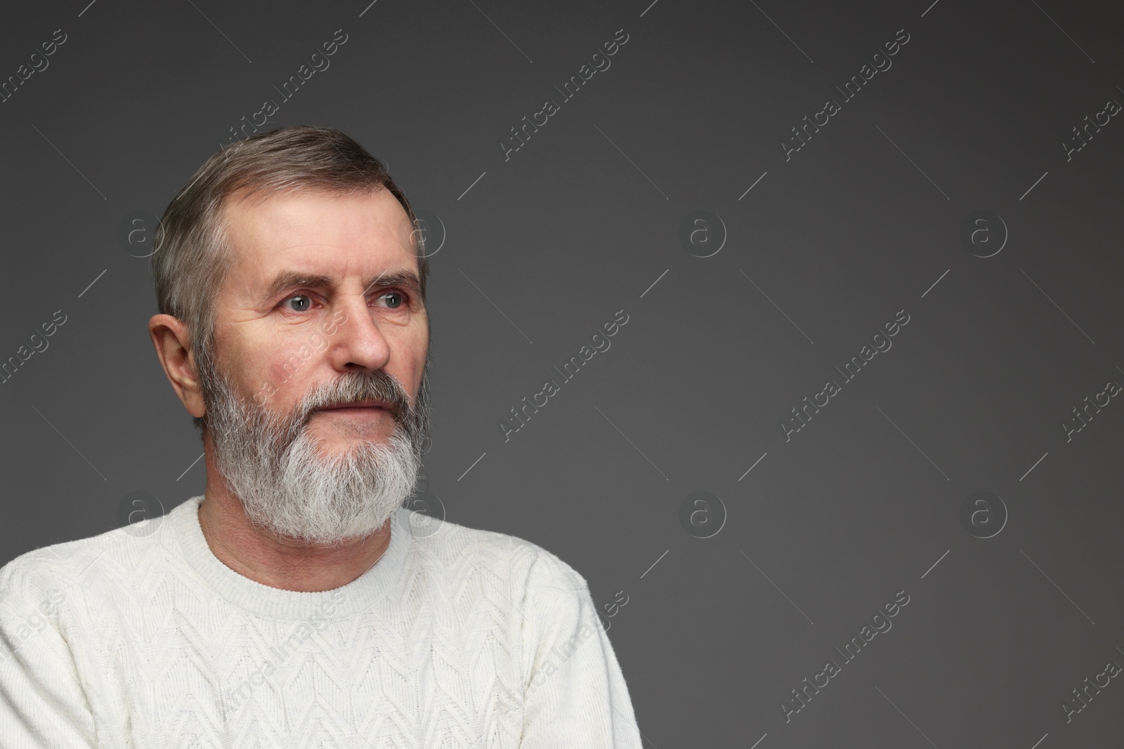 Photo of Portrait of mature man on grey background, space for text