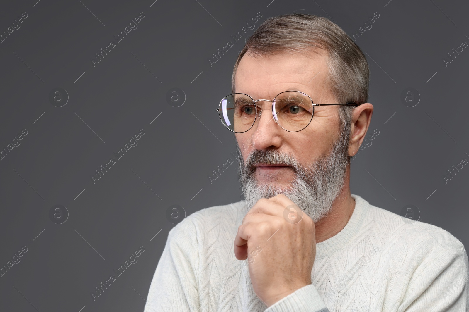 Photo of Portrait of mature man in glasses on grey background, space for text