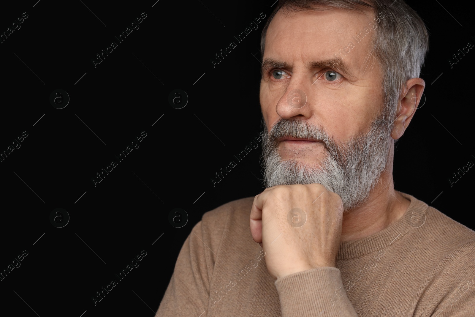 Photo of Portrait of mature man on black background, space for text