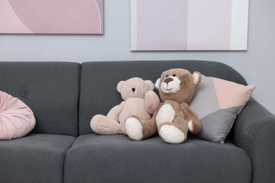 Photo of Teddy bears and pillows on sofa in room