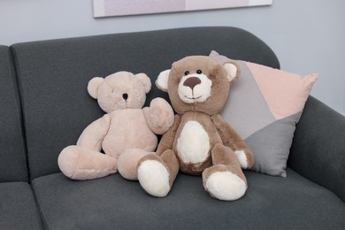 Photo of Teddy bears and pillow on sofa in room