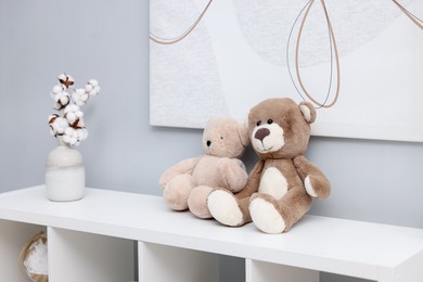 Photo of Teddy bears on shelving unit in room