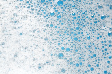 Photo of Detergent foam with bubbles as background, top view