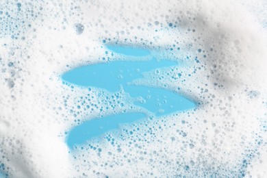 Photo of Detergent foam with bubbles on light blue background, above view